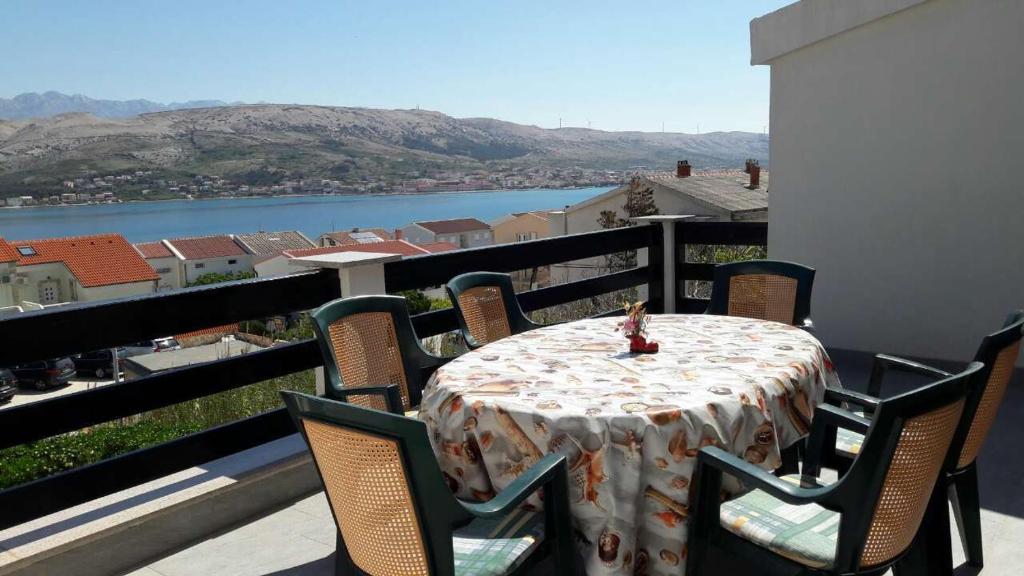 a table and chairs on a balcony with a view at Apartment Anja in Pag