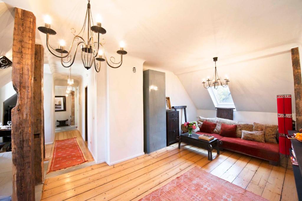 a living room with a red couch and a chandelier at Luxury Moroccan in Tallinn