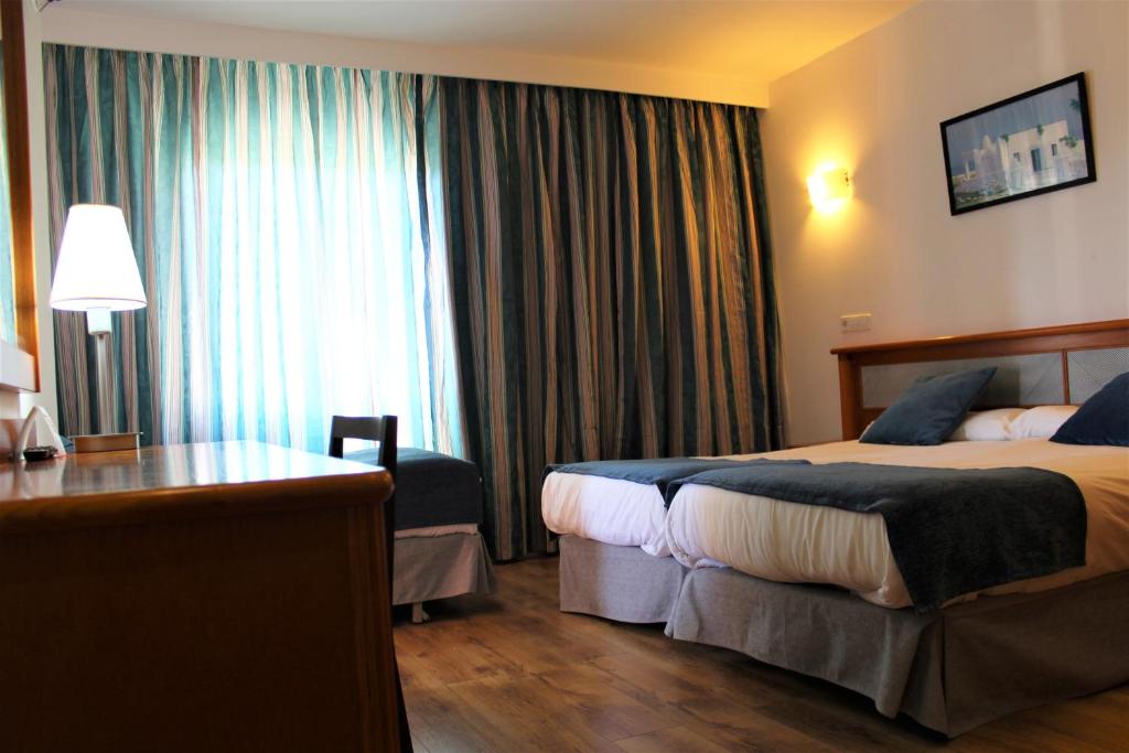 Posteľ alebo postele v izbe v ubytovaní Hotel Marbel
