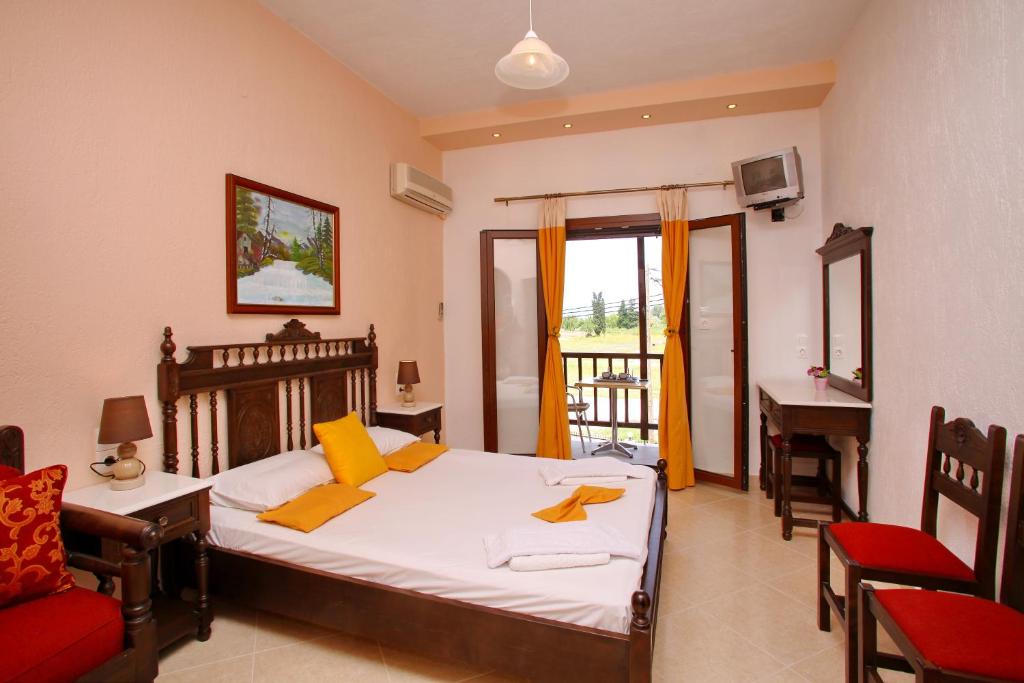 a bedroom with a bed and a table and a desk at Maria Studios in Neo Klima