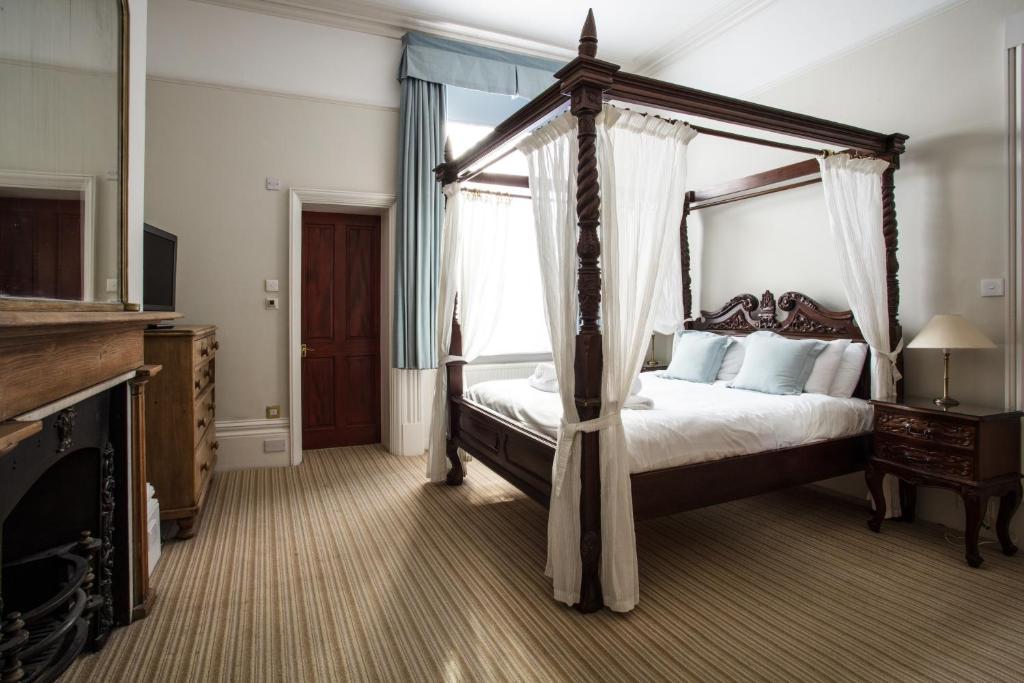 a bed room with a large bed and a large window at Brighton House in Brighton & Hove
