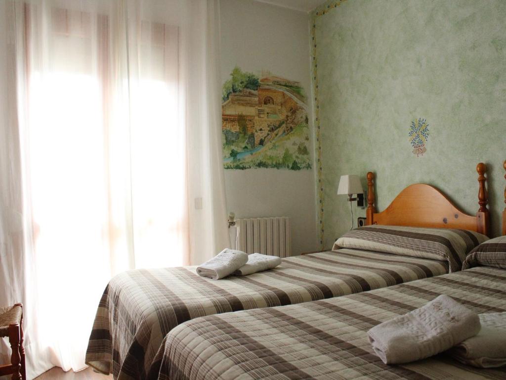Postel nebo postele na pokoji v ubytování Hotel Casa Domenc