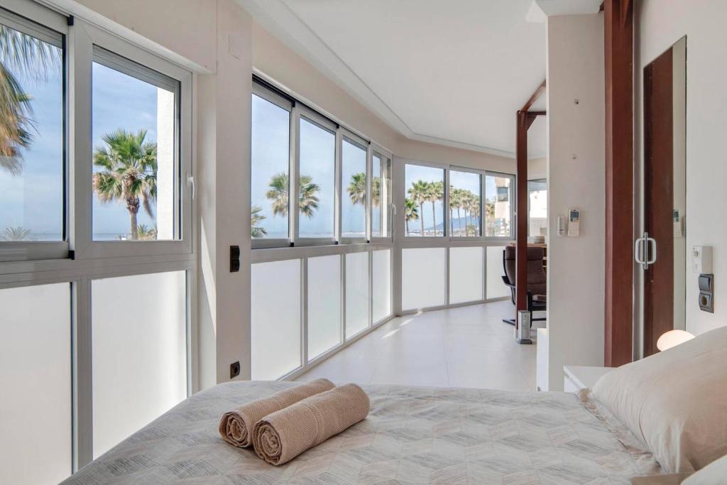 a bedroom with a bed with two rolled towels on it at Luxury Views Marbella in Marbella
