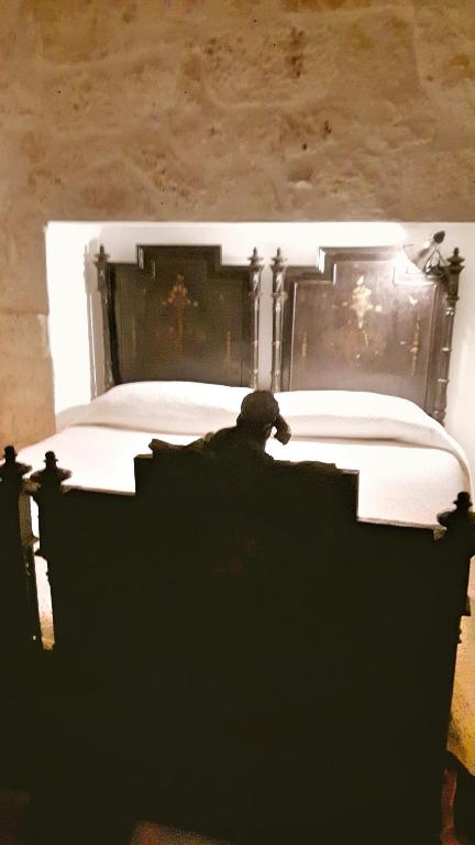 A bed or beds in a room at Trulli Spinosa