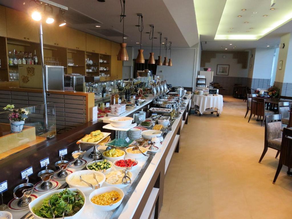 a buffet line with many plates of food at Ueda Tokyu REI Hotel in Ueda
