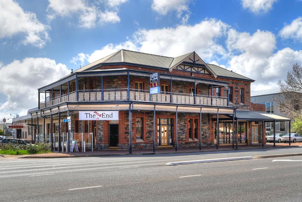 a large brick building on the corner of a street at The Mile End Hotel in Adelaide