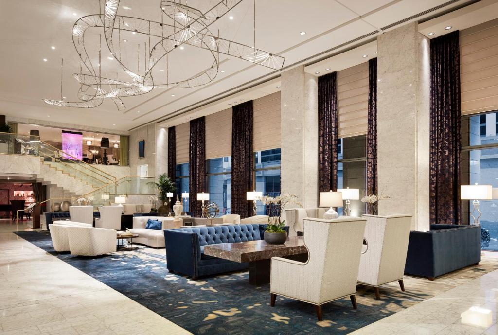 a lobby with couches and chairs and a chandelier at Hotel Nikko San Francisco in San Francisco