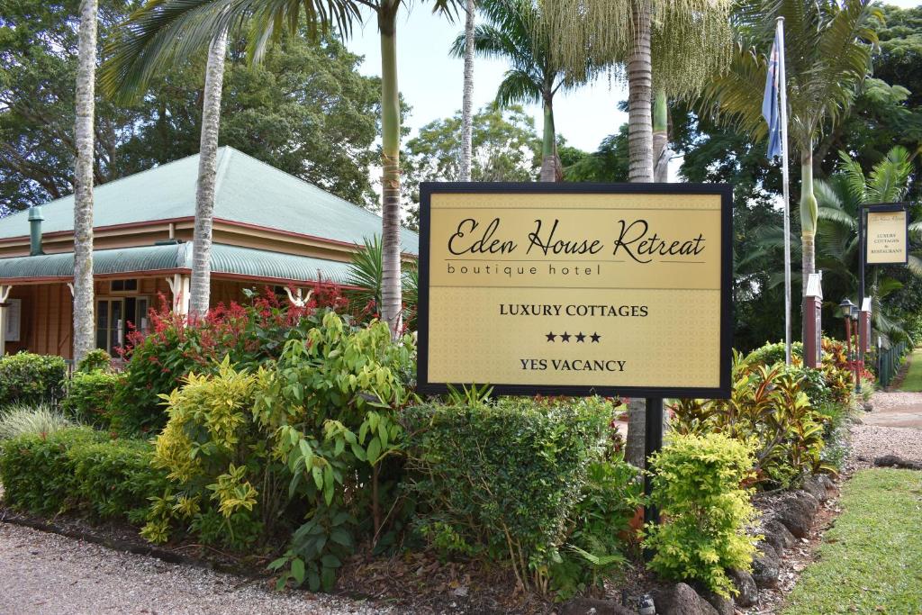 a sign for a hotel in front of a building at Eden House Retreat in Yungaburra