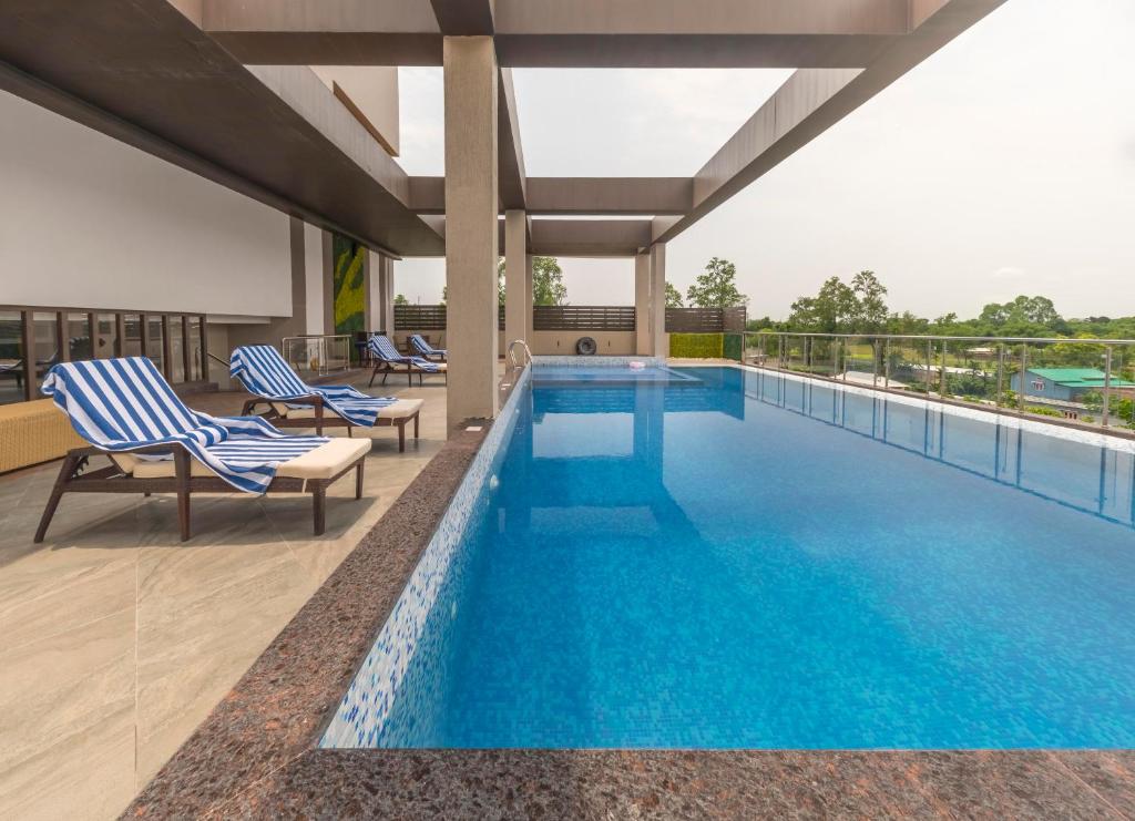 a swimming pool on the roof of a building at Cygnett Park Meghna in Bongaigaon