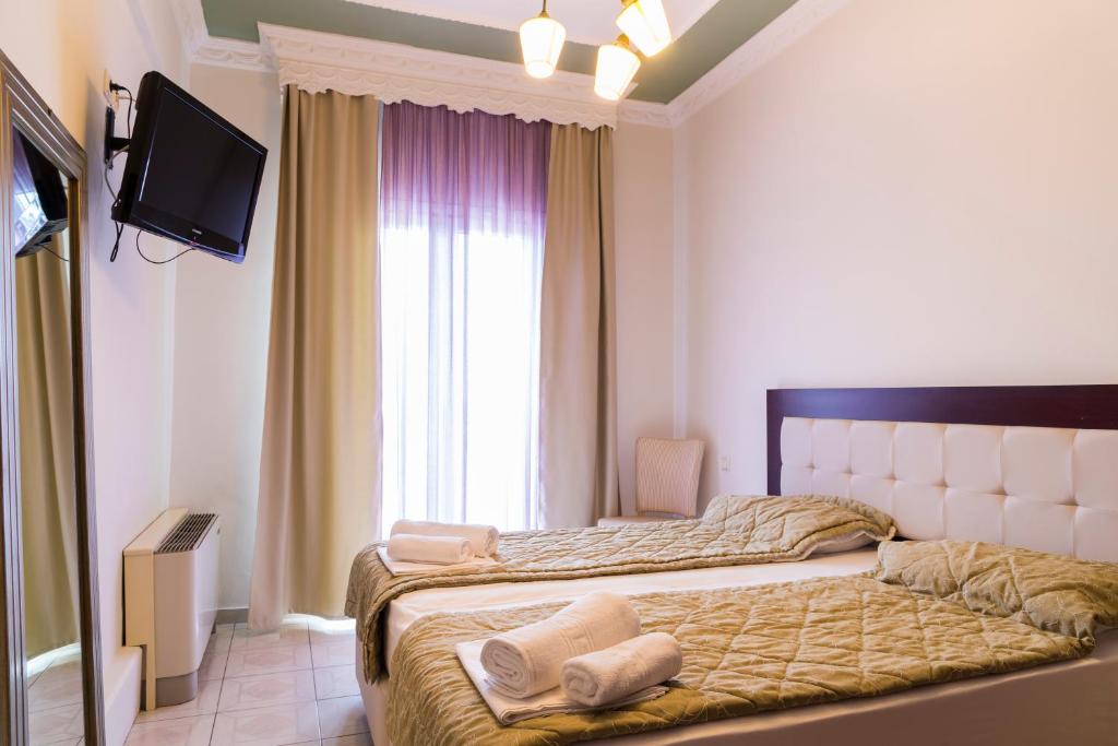 Postel nebo postele na pokoji v ubytování Hotel Zografos