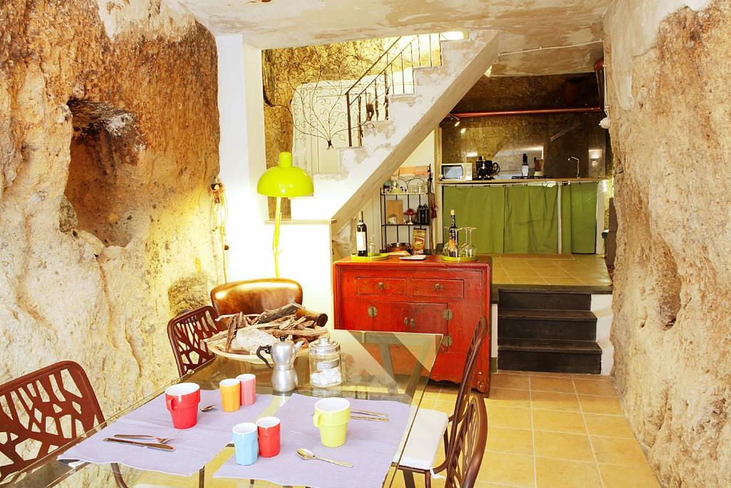 a dining room with a table and a kitchen at Aghinas in Bosa