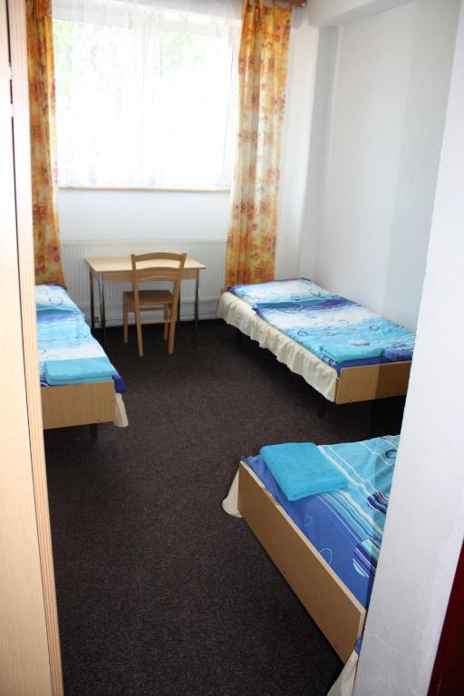 Postel nebo postele na pokoji v ubytování Sporthotel BK Pod Lipou