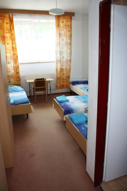 Postel nebo postele na pokoji v ubytování Sporthotel BK Pod Lipou
