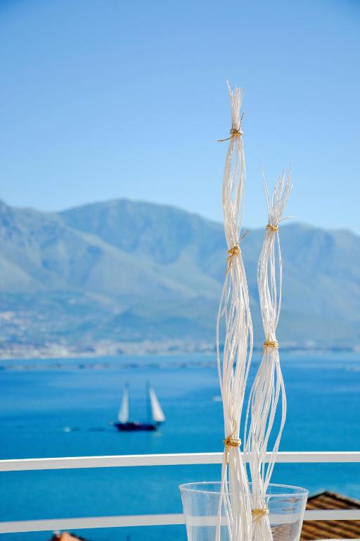 a group of plastic cups with a boat in the water at Il Bottone al Duomo in Gaeta