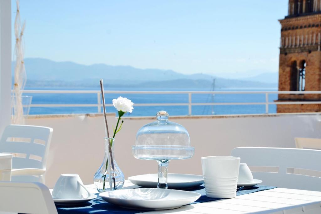 a table with a glass container and a flower on it at Il Bottone al Duomo in Gaeta