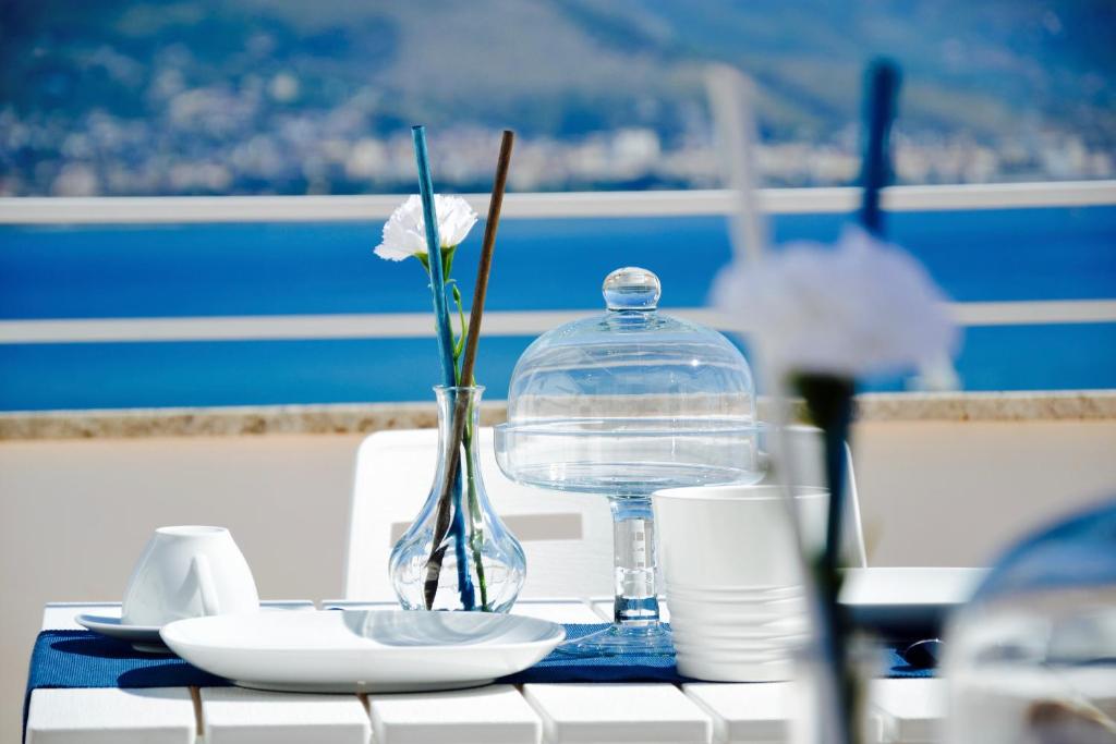 a table with a bottle and a flower in a vase at Il Bottone al Duomo in Gaeta