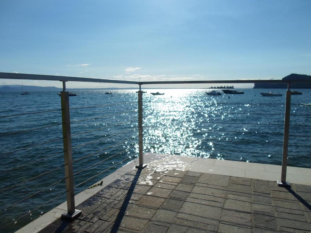 a view of the water from a pier at Il volto del lago - Rooms&Apartments in San Felice del Benaco