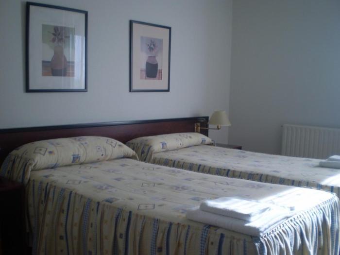 Postel nebo postele na pokoji v ubytování Hostal Abodi