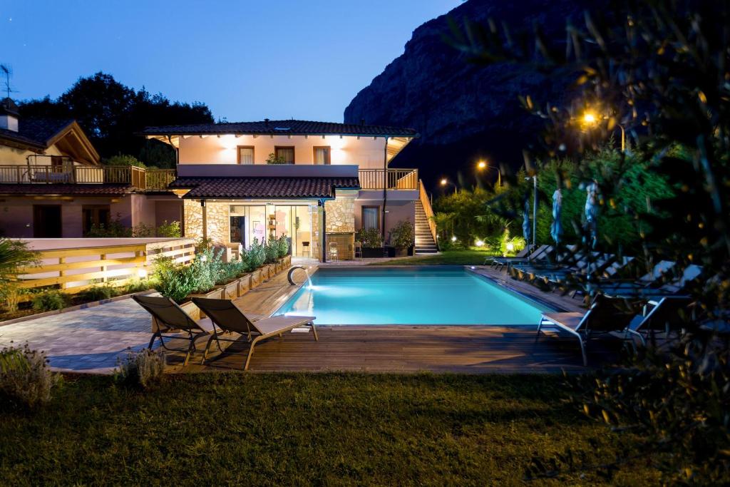 a house with a swimming pool at night at Agriturismo Vin e Amor in Dro
