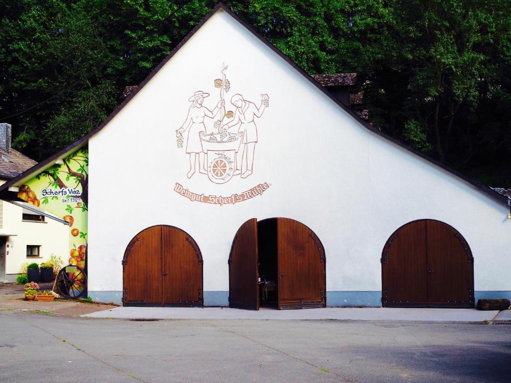 a church with a painting on the side of it at Scherfsmühle am Mühlbach in Waldrach