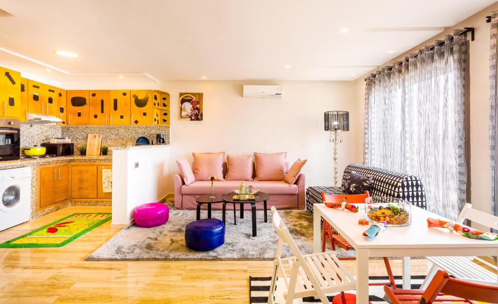 a living room with a couch and a kitchen at Appartement Mogador CASABLANCA in Casablanca