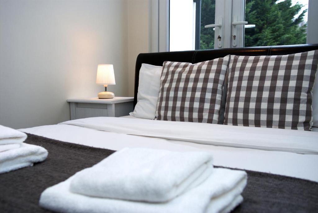 a bedroom with a bed with white towels on it at Guest House London in London