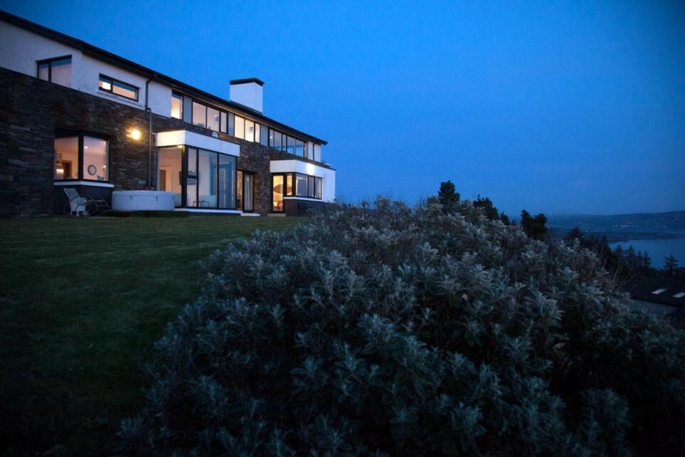 a house on top of a hill at night at Sea Vista Boutique Accommodation in Fahan