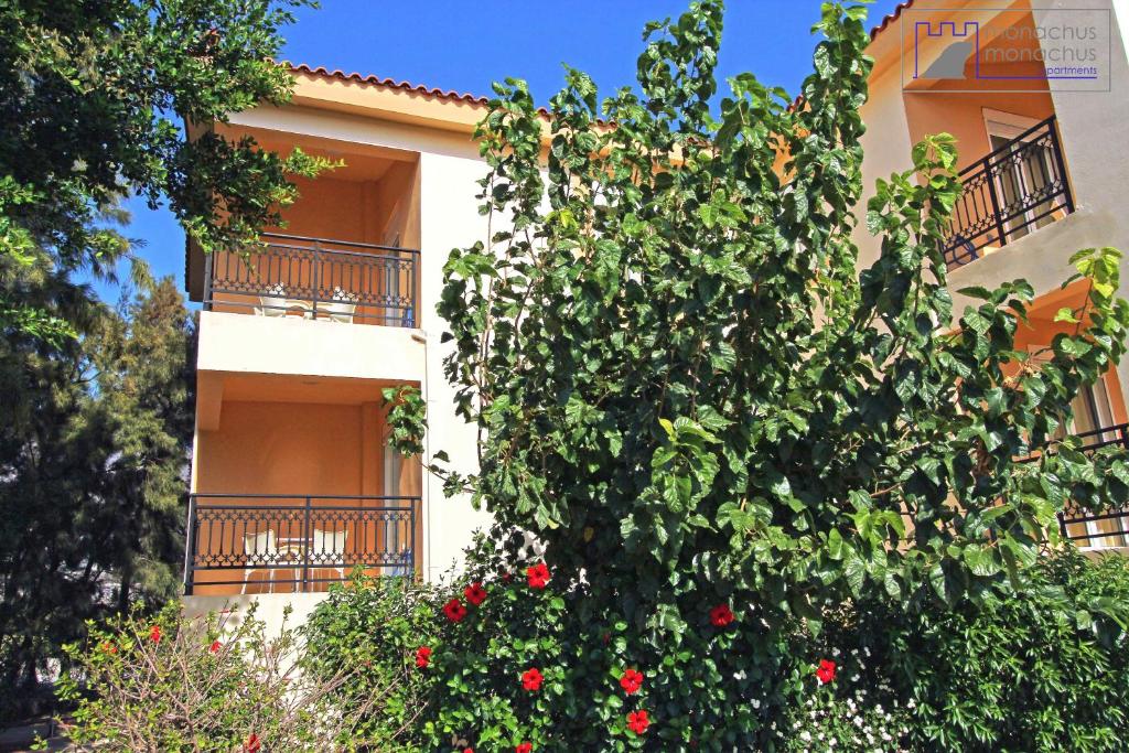 a building with red flowers in front of it at Monachus Monachus in Frangokastello