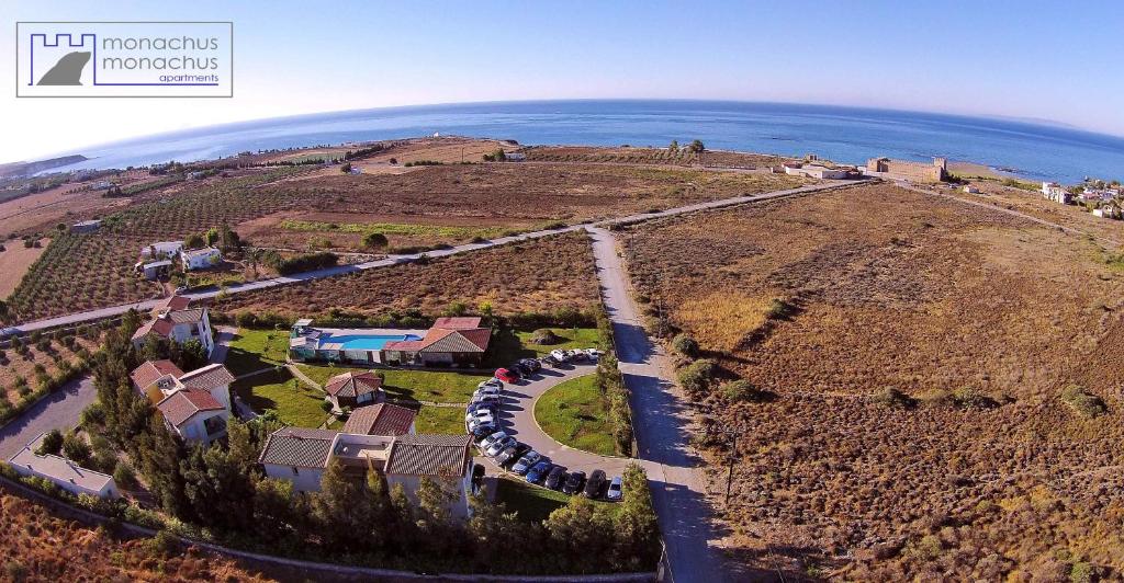 an aerial view of a house on a hill with the ocean at Monachus Monachus in Frangokastello