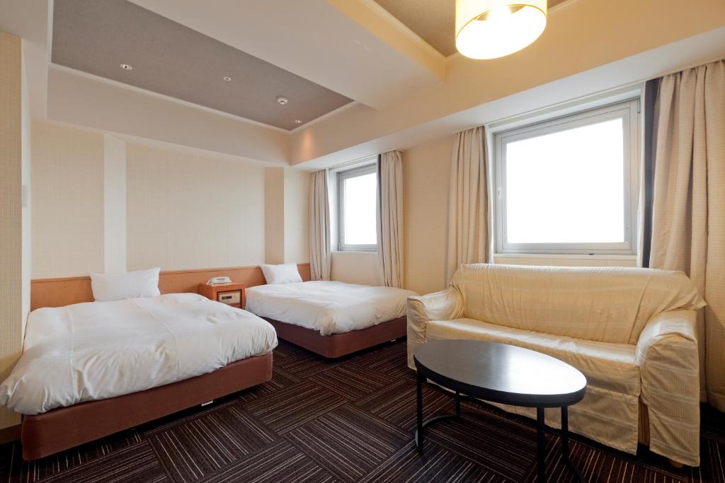 Postel nebo postele na pokoji v ubytování Kanku Izumiotsu Washington Hotel
