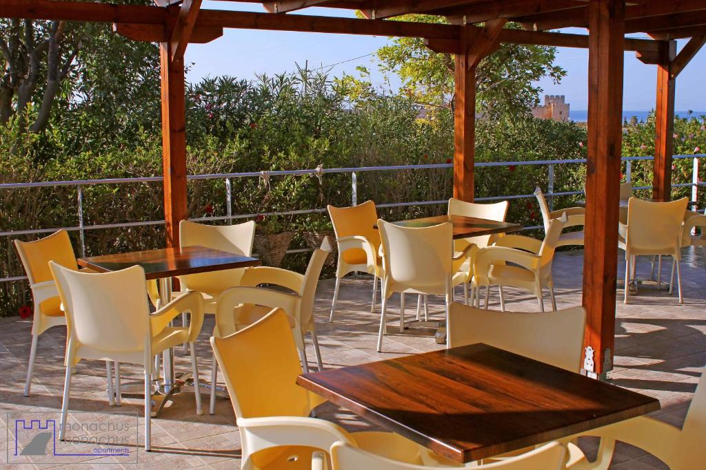 a group of tables and chairs on a patio at Monachus Monachus in Frangokastello