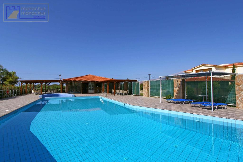 a large swimming pool with blue tiles on it at Monachus Monachus in Frangokastello