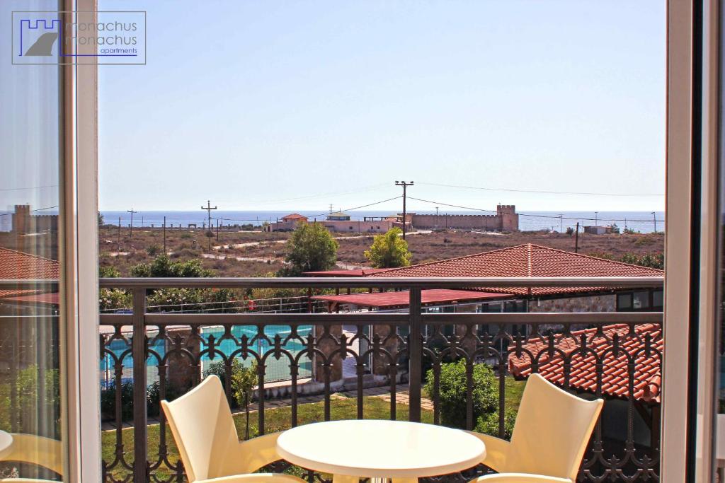 a view from a balcony with a table and chairs at Monachus Monachus in Frangokastello