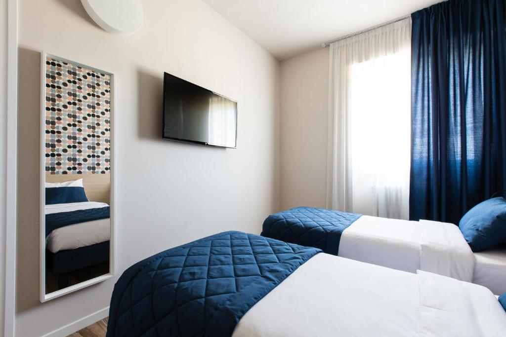 Postel nebo postele na pokoji v ubytování Aparthotel Isola
