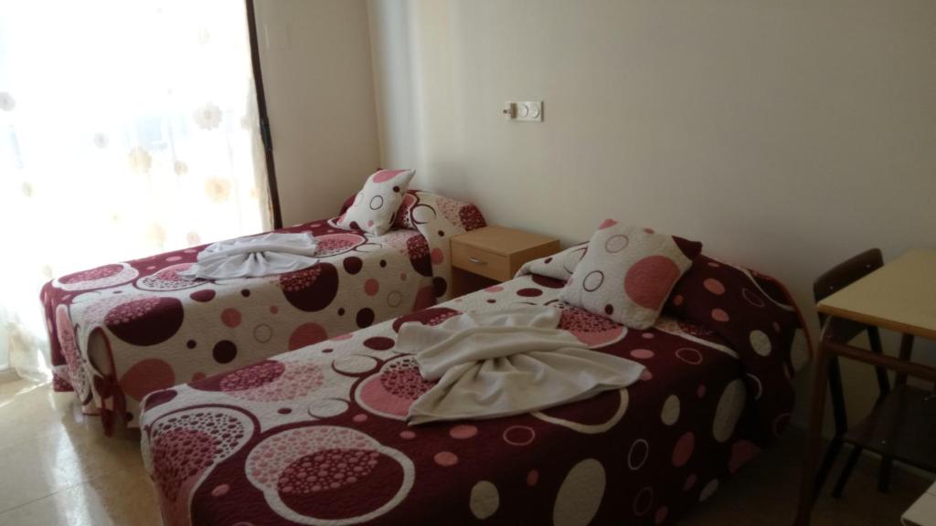 Postel nebo postele na pokoji v ubytování Hostal Huespedes Toledo