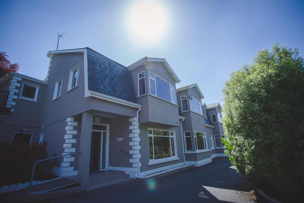 a large house with the sun shining on it at Diamond Hill Country House in Waterford