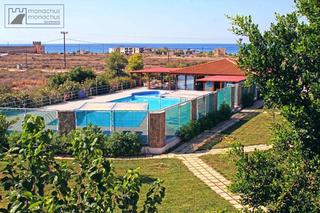 a villa with a swimming pool and the ocean at Monachus Monachus in Frangokastello