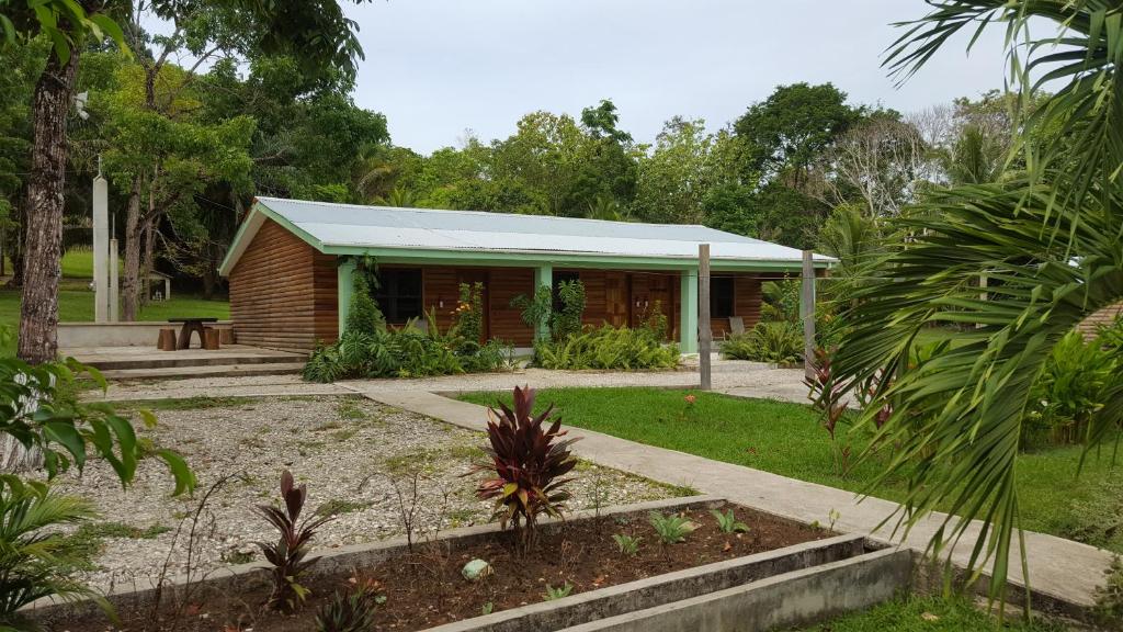 a building with a green roof in a garden at Mahogany Villas in Punta Gorda