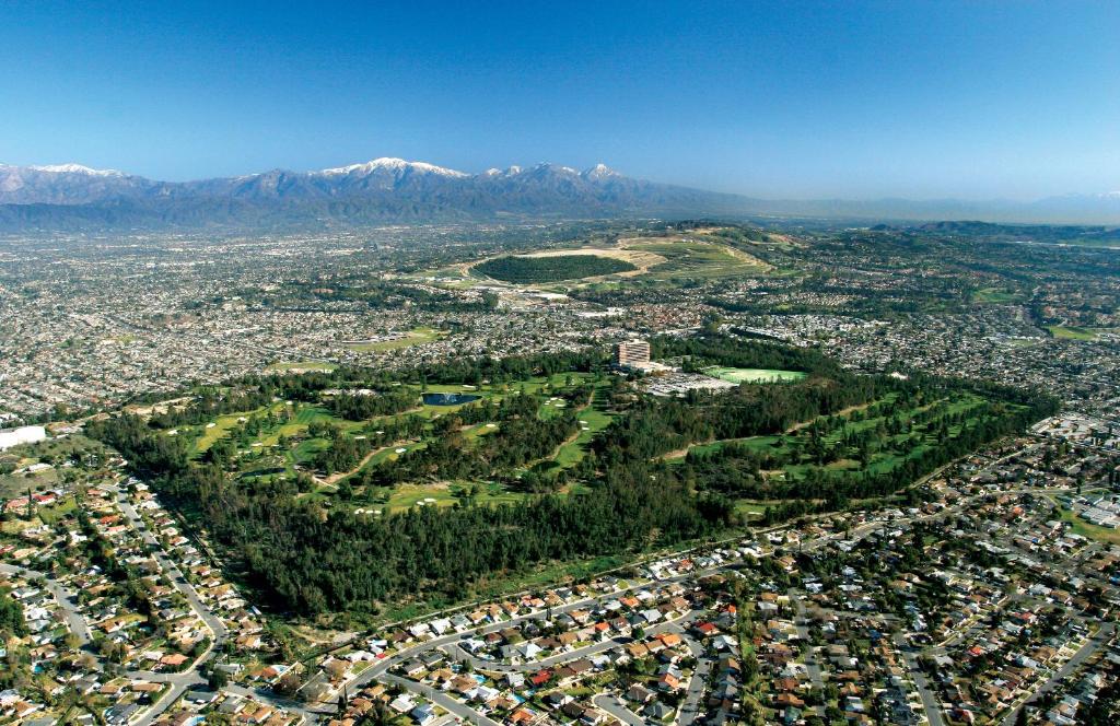 an aerial view of a city with mountains in the background at Pacific Palms Resort and Golf Club in La Puente