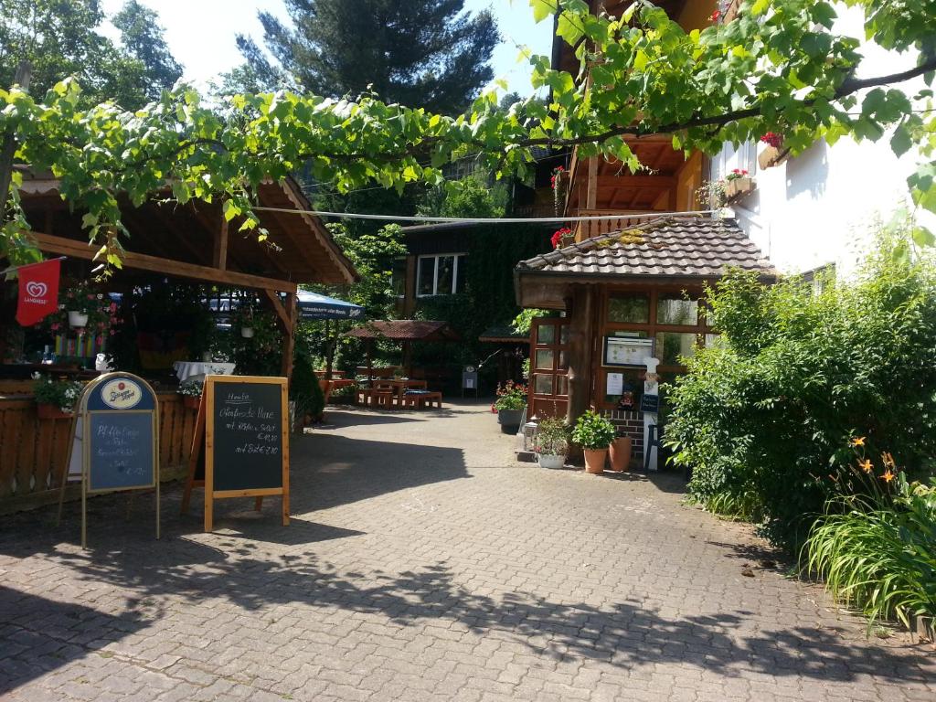 a cobblestone street with a shop and a building at Landgasthof Linkenmühle in Hornbach