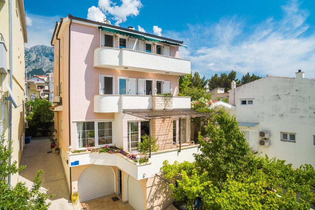 an apartment building with a balcony in a city at House Coko in Baška Voda