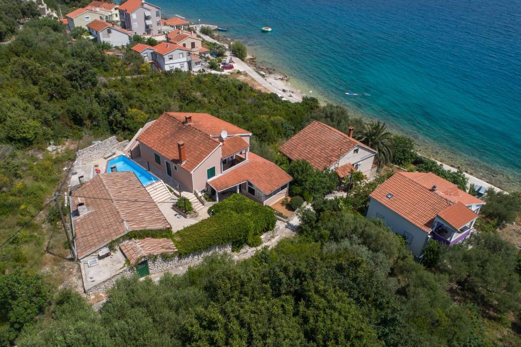 an aerial view of a house on a hill next to the ocean at Villa Lily in Veli Iž