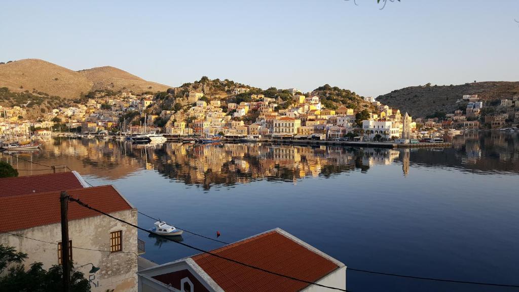 a large body of water with houses and boats at Pitini in Symi