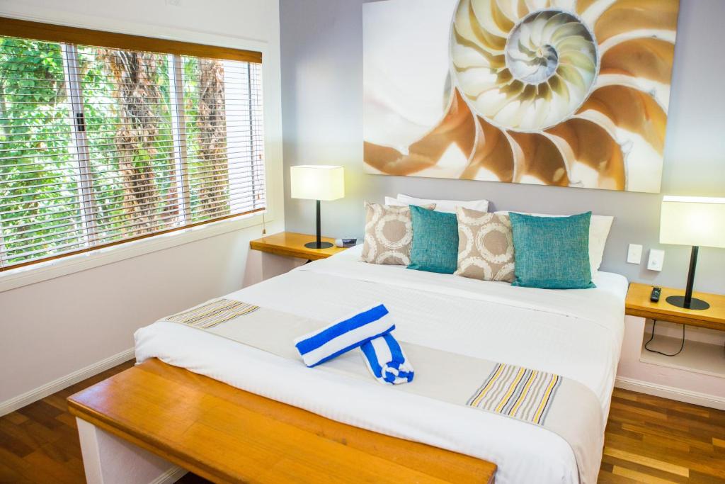 two beds in a room with two lamps at Alamanda - Suite 46 in Palm Cove