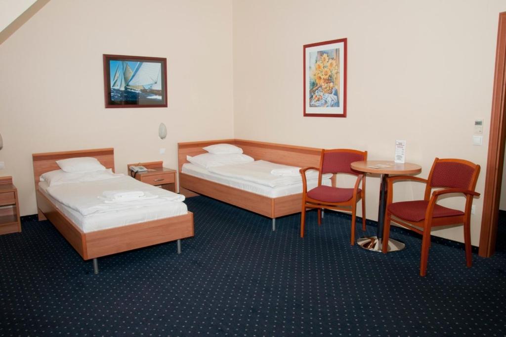 Ένα ή περισσότερα κρεβάτια σε δωμάτιο στο Hotel Paprika