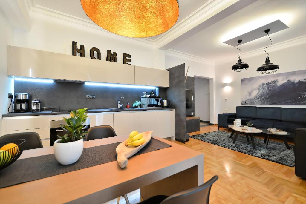 a kitchen and living room with a table and chairs at Acropolis Executive Suite in Athens