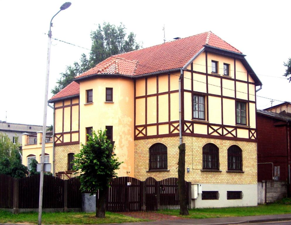 a large house with a fence in front of it at Villand Hotel with Free Private Parking and Self Check In in Riga