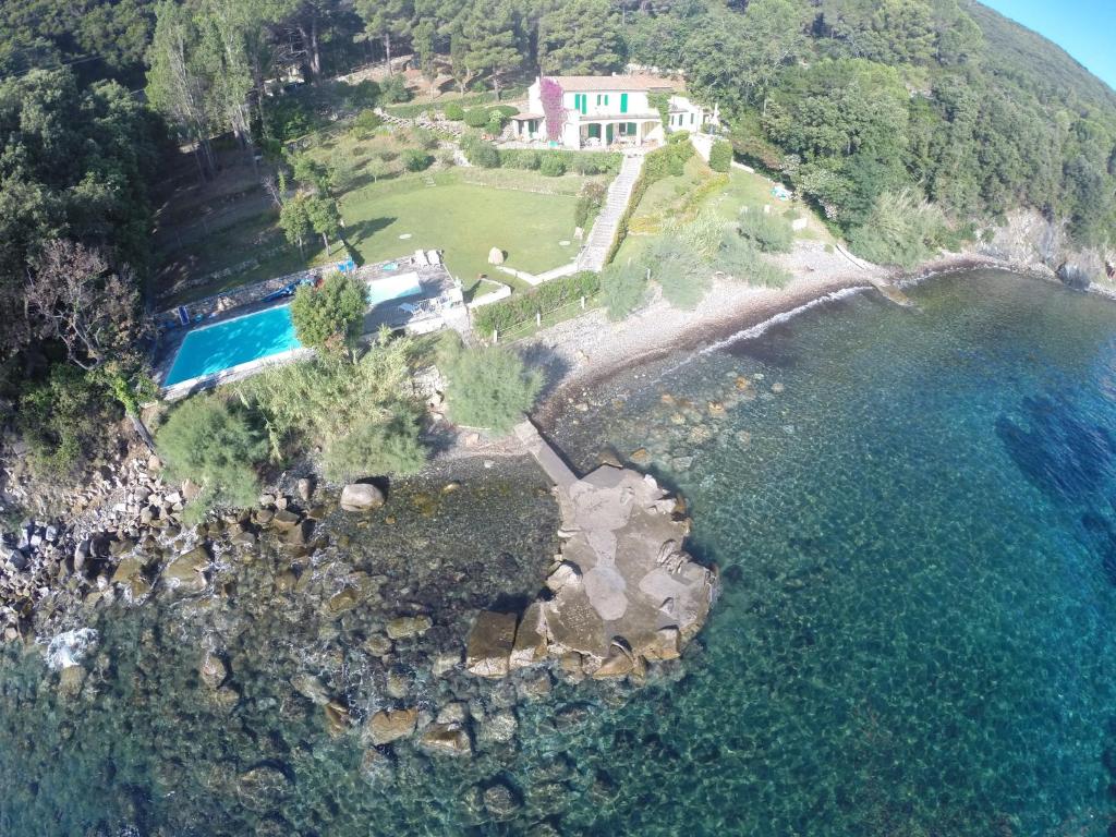 an aerial view of a house on a hill by the water at Residenza Le Sprizze in Bagno