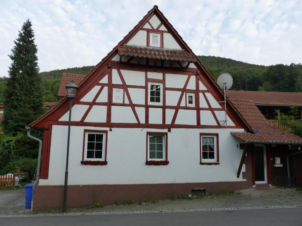 a white and red house with a roof at Ferienhaus Katharina in Nothweiler