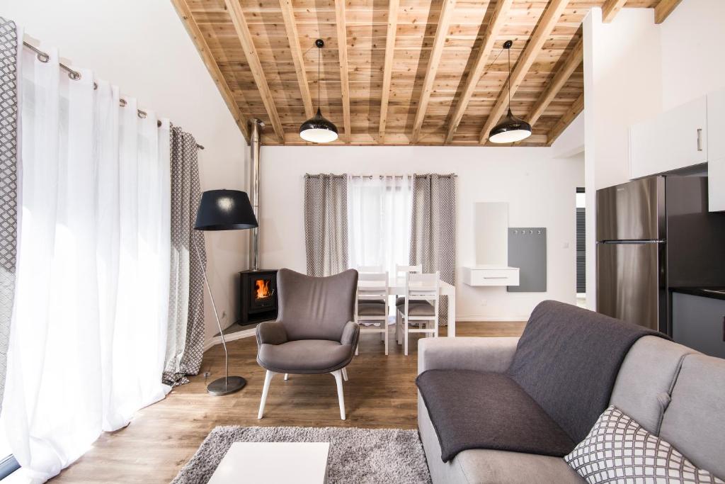 a living room with a couch and a chair at Casas do Caminho Novo in São Roque do Pico